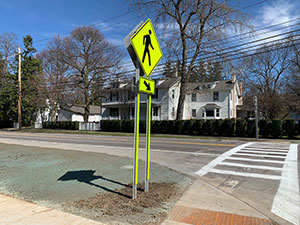 Pedestrian safety sign in bright green